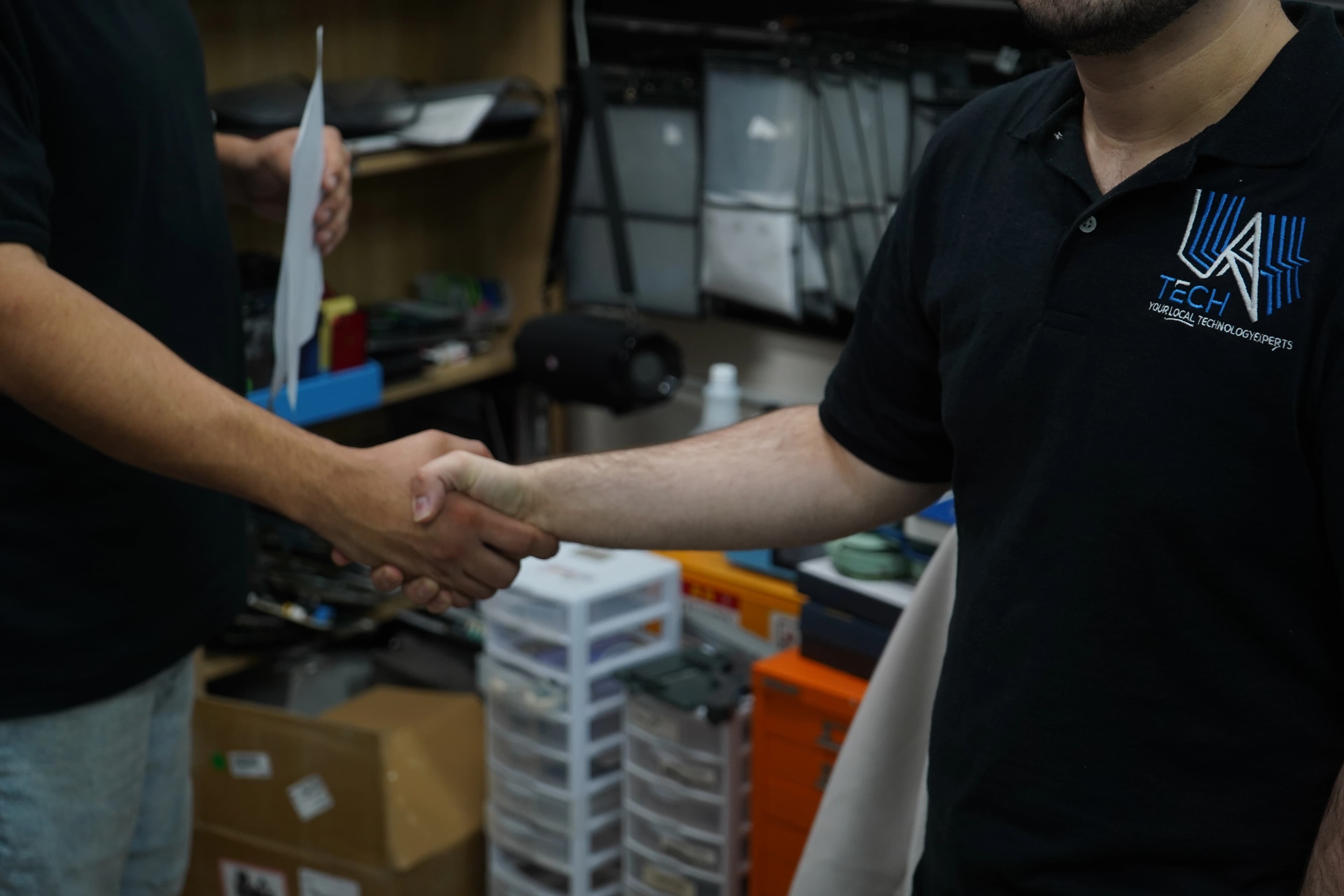 LA Tech specialist sealing a trusted partnership with a client handshake